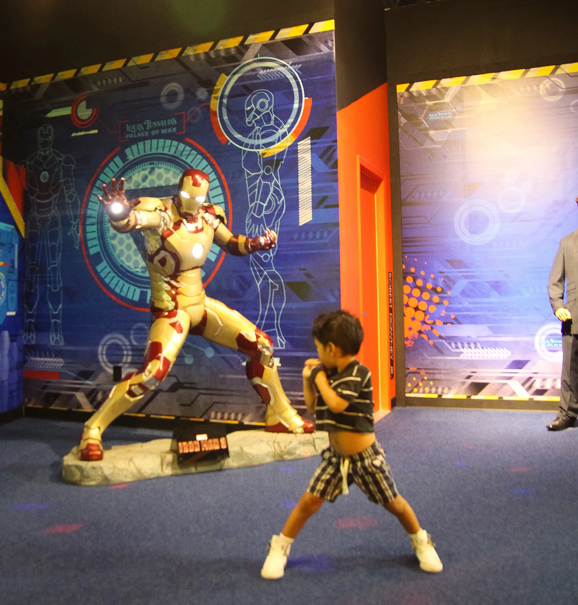Kid standing in front of Iron Man in Grand Prairie Texas