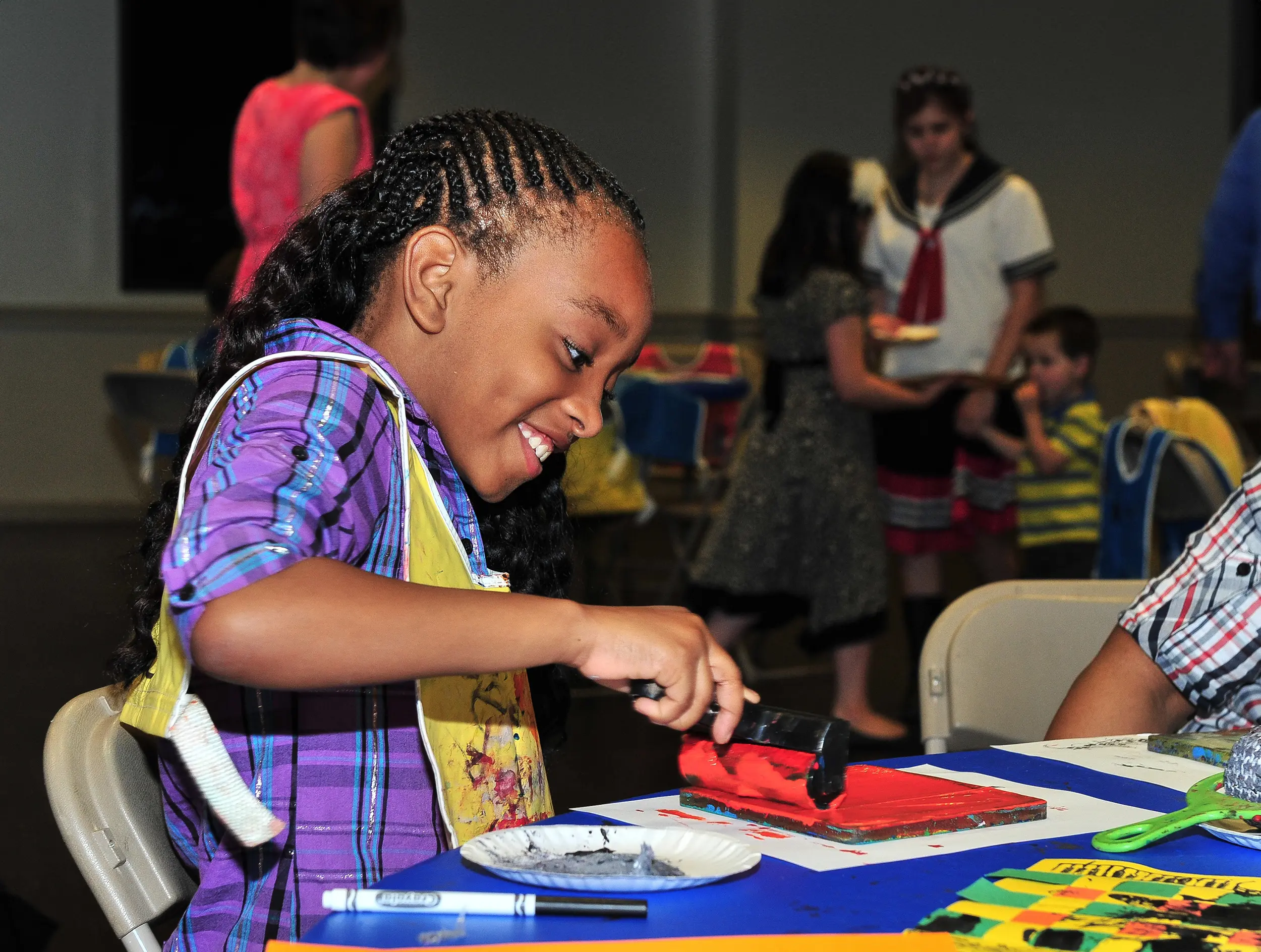 Girl working on an art project at Irving Arts Center